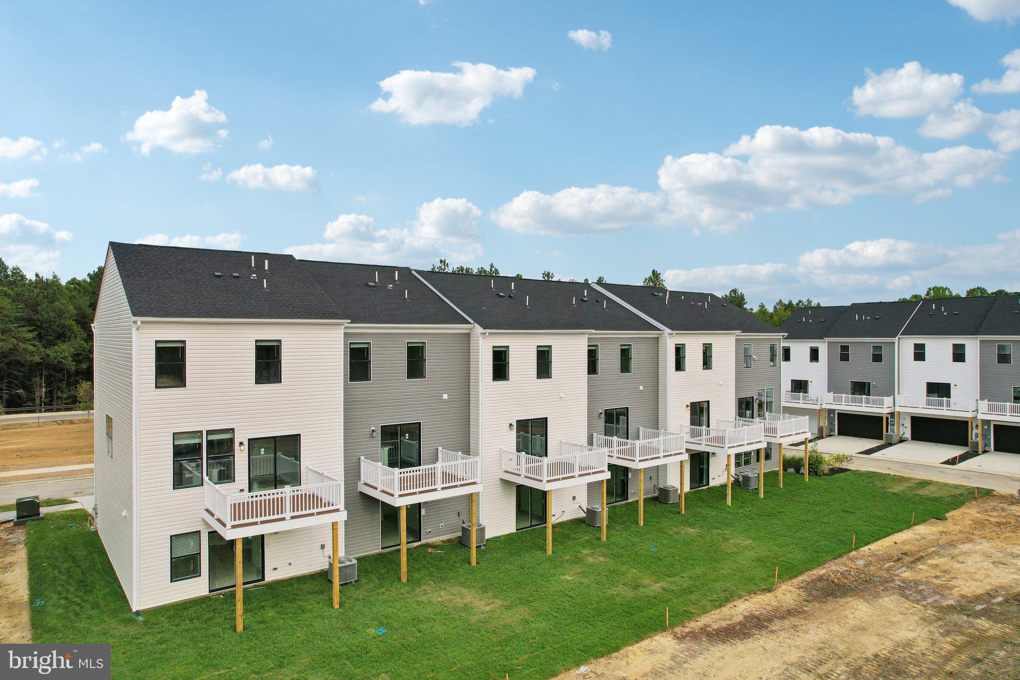 466 Still Feather Avenue La Plata, MD 20646 - Photo 89 of 89 a view of a white house with a big yard and potted plants
