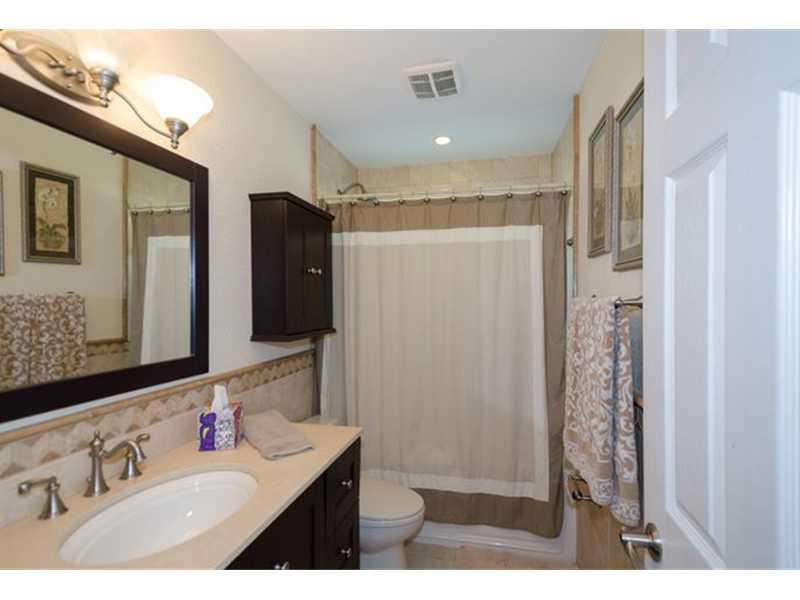 17201 Southwest 48th Street Southwest Ranches, FL 33331 - Photo 7 of 8 a bathroom with a sink vanity and a mirror
