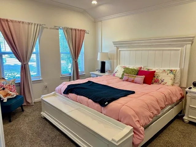 a bedroom with two beds and a large window