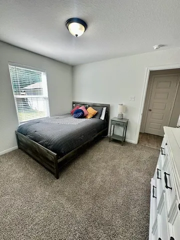 a bedroom with a bed and a window