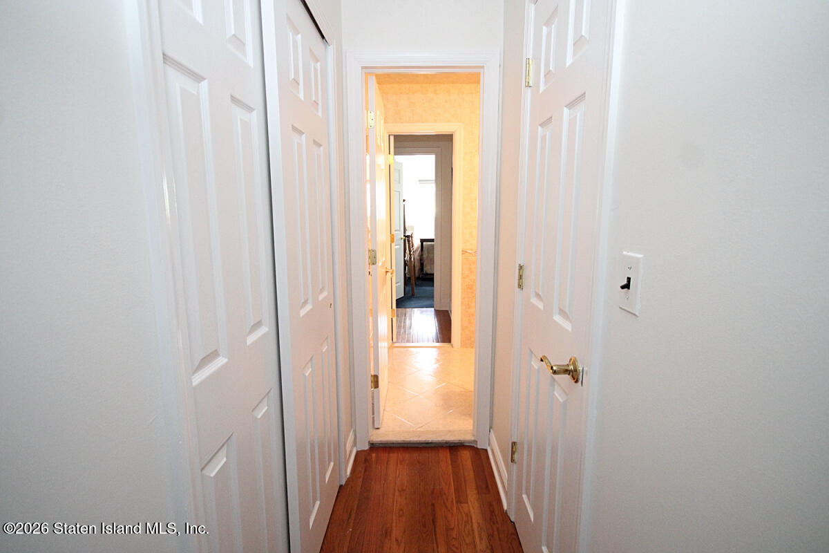 951 West Fingerboard Road Staten Island, NY 10304 - Photo 19 of 29 a view of a hallway with wooden floor and a bathroom