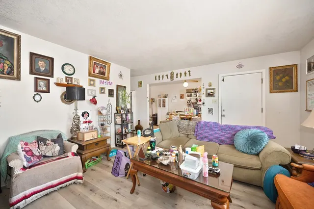 a bathroom with a toilet a sink a large mirror and shower