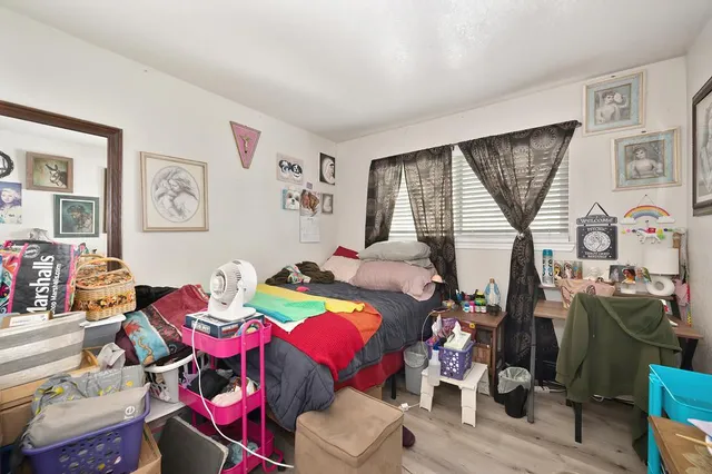 a bedroom with a bed and a book shelf