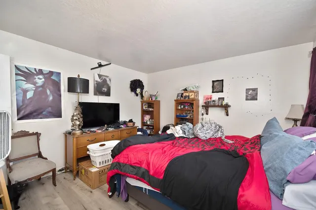 a living room with furniture a flat screen tv and a window