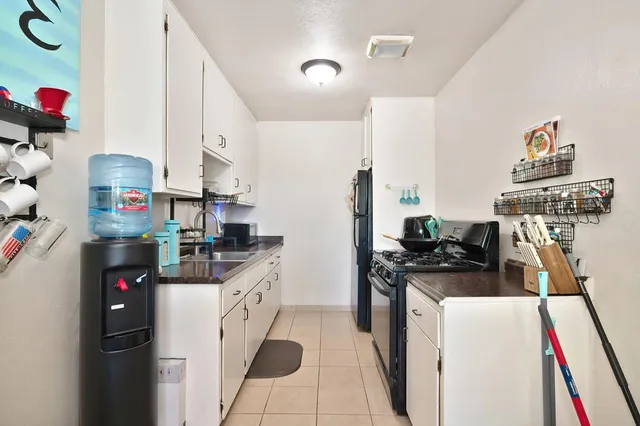 a bathroom with a sink vanity mirror and toilet