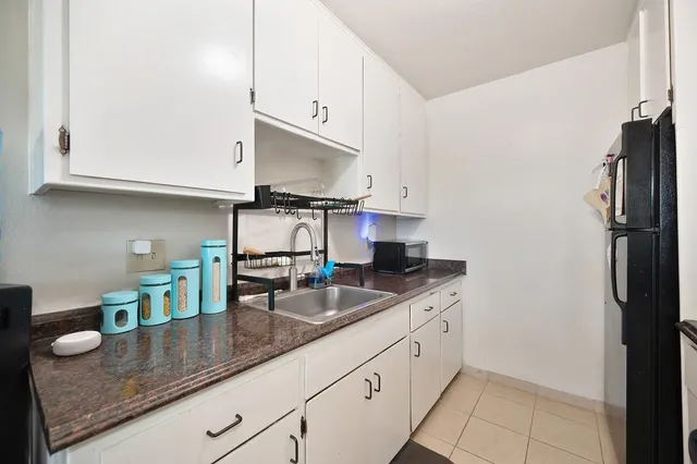 a kitchen with stainless steel appliances kitchen island granite countertop a stove and a sink