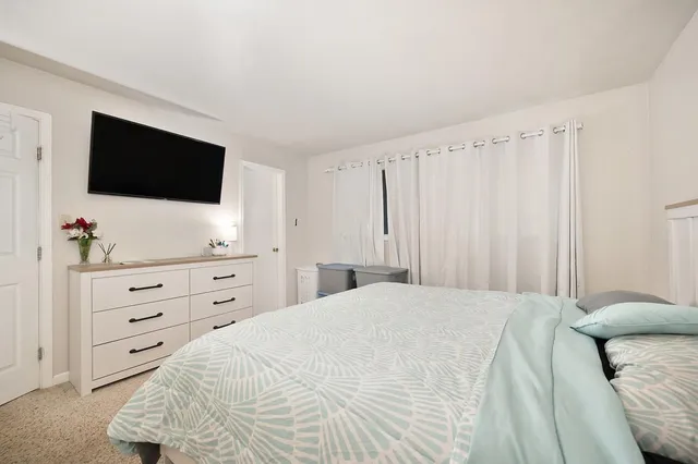 a bedroom with furniture and a window