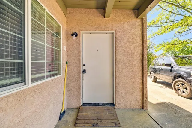 a bed room with a bed a flat screen tv and dresser