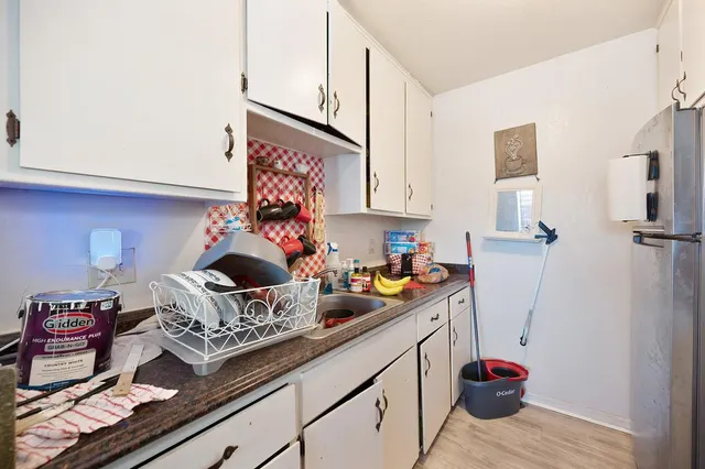 a living room with furniture a flat screen tv and a large window