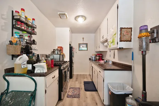 a kitchen with a sink cabinets and a window