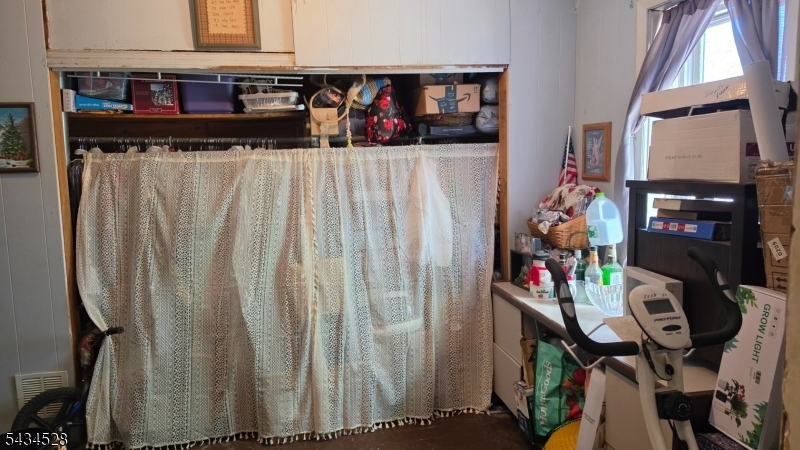 1115 West Camplain Road Manville, NJ 08835 - Photo 14 of 18 a view of walk in closet with clothes and shoes
