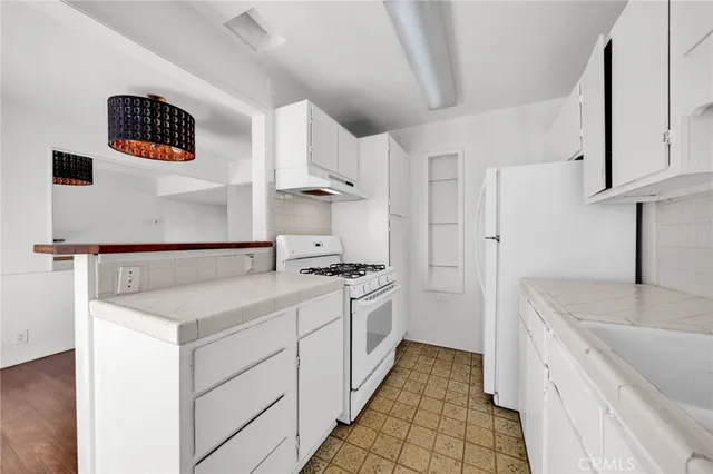 a kitchen with a sink and a stove top oven