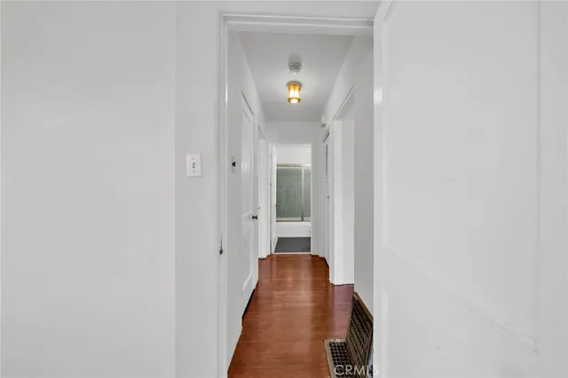 a view of a hallway with a wooden floor