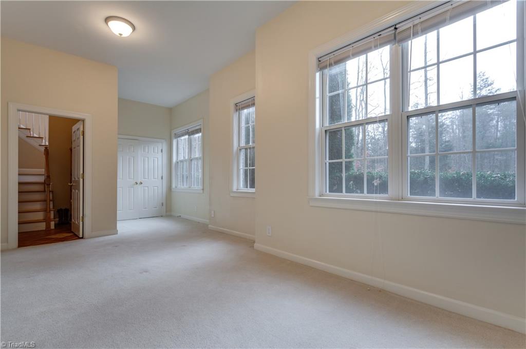6599 Currieton Drive Oak Ridge, NC 27310 - Photo 18 of 30 The basement bedroom is flooded with natural light and features a separate sitting area!