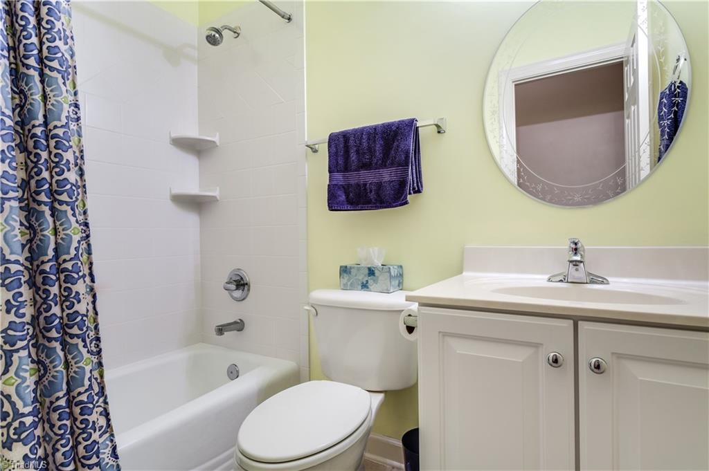 6599 Currieton Drive Oak Ridge, NC 27310 - Photo 19 of 30 The 3rd full bathroom is in the basement, to be shared with the 4th bedroom or guests, just off of the recreation room.