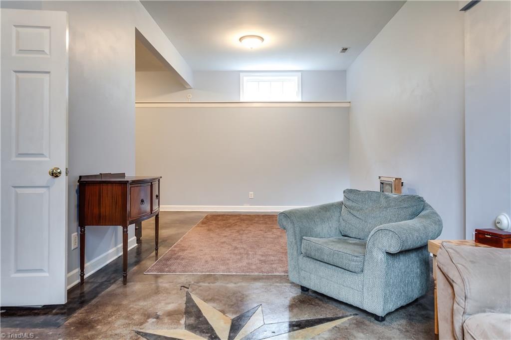 6599 Currieton Drive Oak Ridge, NC 27310 - Photo 22 of 30 Another view of the basement recreation area doesn't even show around the corner with additional rec space! Possibilities are endless.