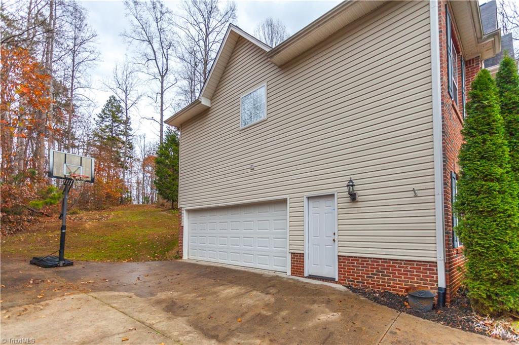 6599 Currieton Drive Oak Ridge, NC 27310 - Photo 27 of 30 The oversized driveway and spacious two car garage offers plenty of parking!