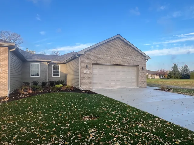 a view of a house with a yard and garage