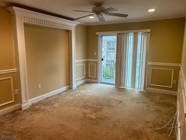an empty room with windows and cabinet