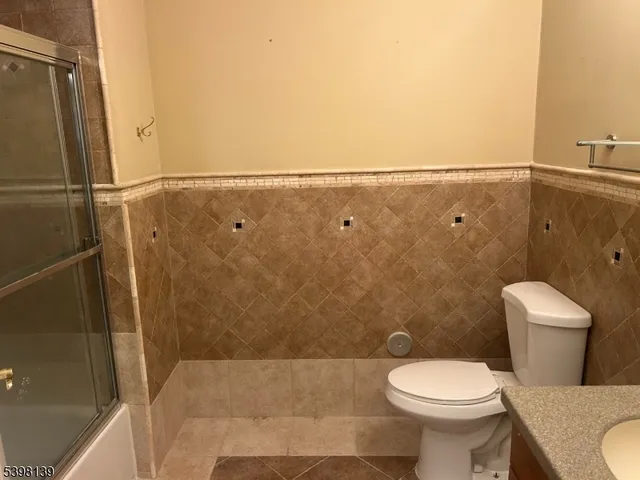 a bathroom with a glass shower door