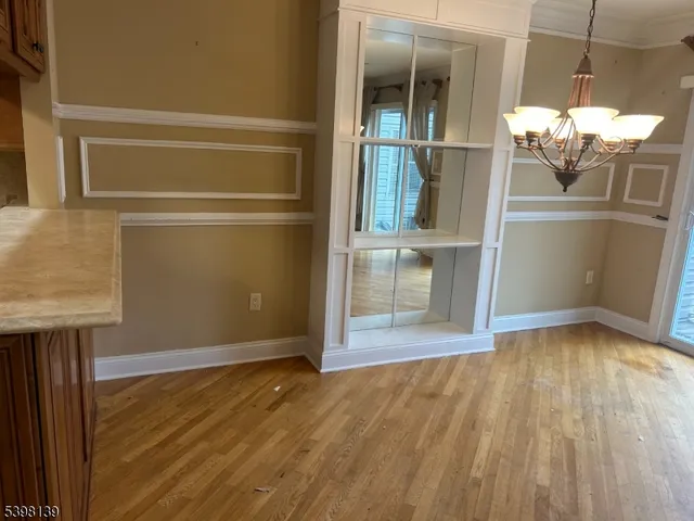 a view of a room with wooden floor and door