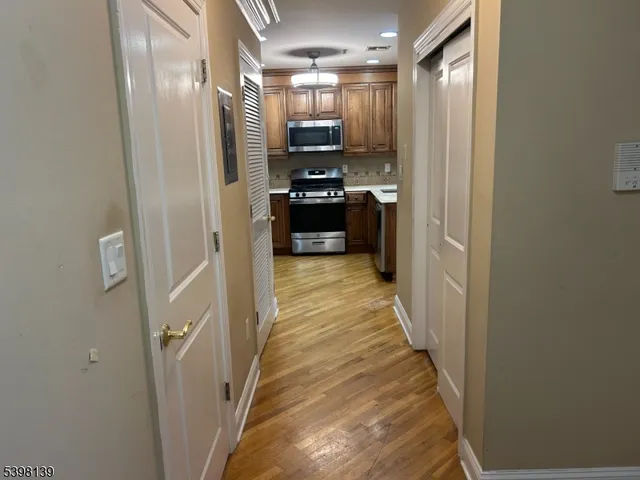 a view of a hallway with wooden floor