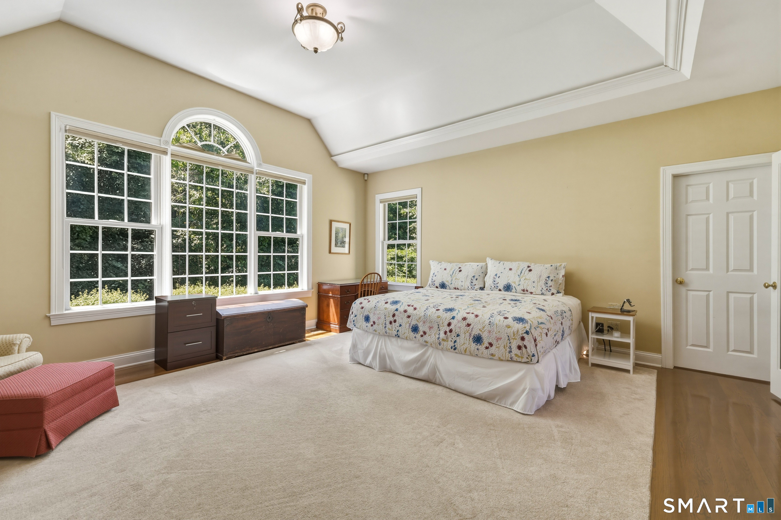 122 Lower Road Guilford, CT 06437 - Photo 13 of 39 A spacious first floor master bedroom suite accessed through French doors and features a cathedral ceiling with a tray detail and ambient lighting. A Palladian window enhances the natural light.