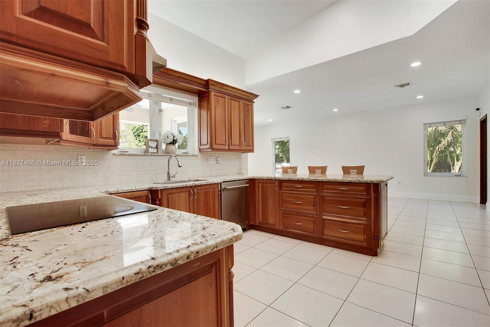 13550 Southwest 82nd Avenue Pinecrest, FL 33156 - Photo 11 of 25 a kitchen with a sink a stove and cabinets