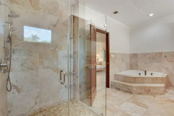 a spacious bathroom with a granite countertop sink a toilet and a shower