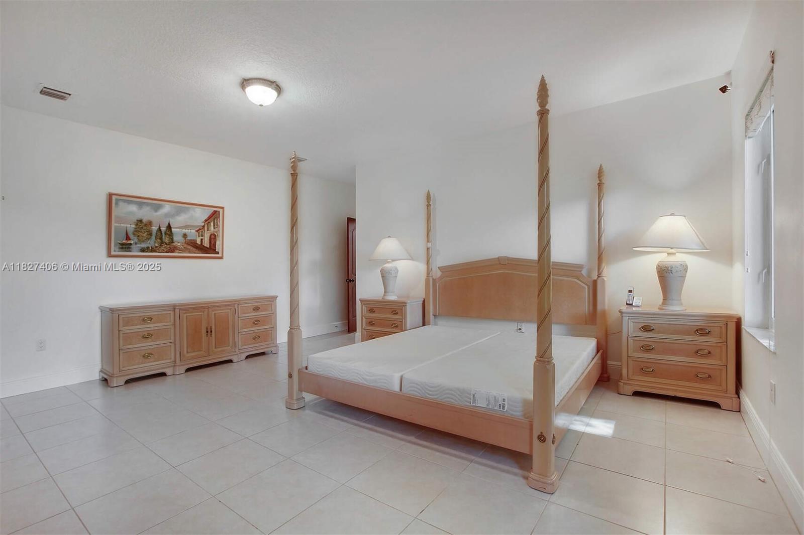 13550 Southwest 82nd Avenue Pinecrest, FL 33156 - Photo 14 of 25 a bedroom with a bed and ceiling fan