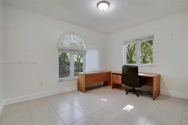 a bedroom with a bed and a mirror