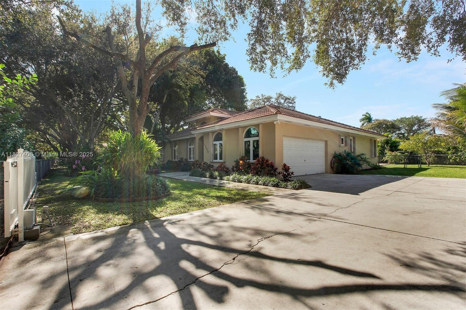 13550 Southwest 82nd Avenue Pinecrest, FL 33156 - Photo 2 of 25 a view of a yard in front view of a house