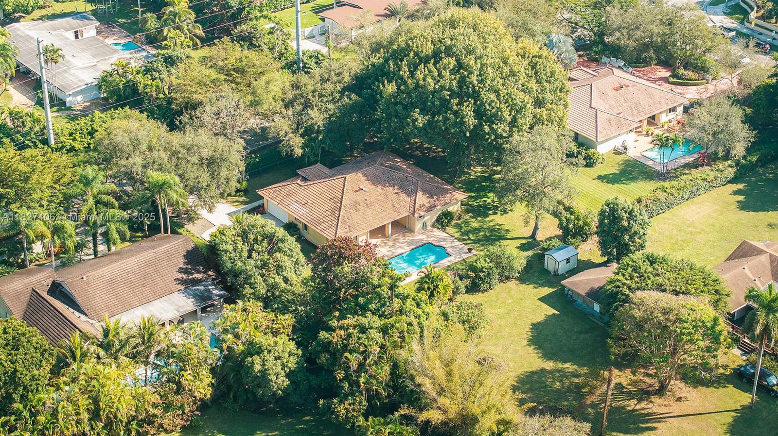 13550 Southwest 82nd Avenue Pinecrest, FL 33156 - Photo 22 of 25 an aerial view of a house with a yard swimming pool and outdoor seating