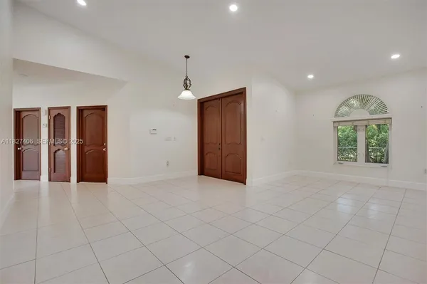 an empty room with windows and closet