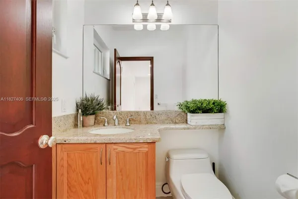 a kitchen with stainless steel appliances granite countertop a table and chairs in it