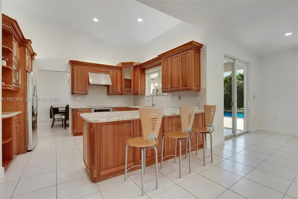 a kitchen with a sink a stove and cabinets