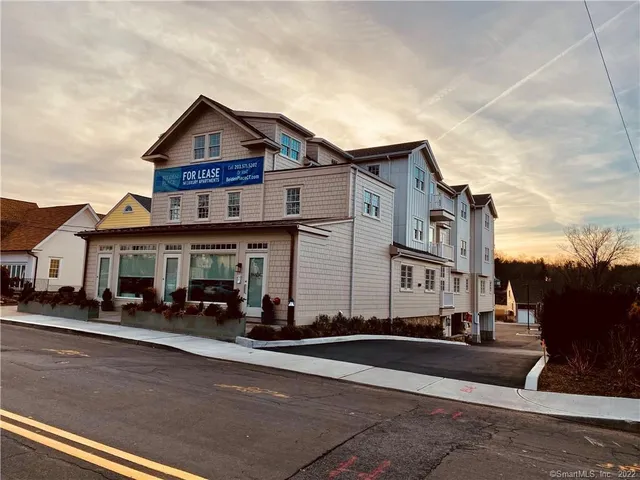 a front view of a house with a street