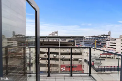 an empty room with wooden floor and ceiling fan