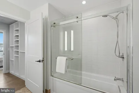 a bathroom with a glass shower door