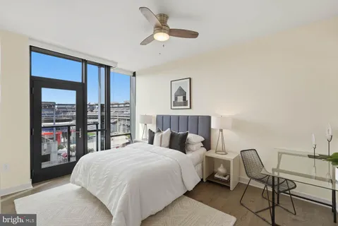 a bedroom with bed and a chandelier