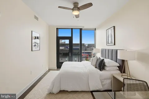 a spacious bathroom with a granite countertop sink and a toilet