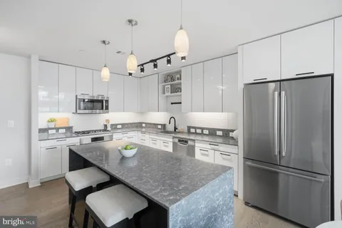 a kitchen with refrigerator a stove a sink and a refrigerator