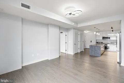 a view of kitchen with stainless steel appliances refrigerator and cabinets