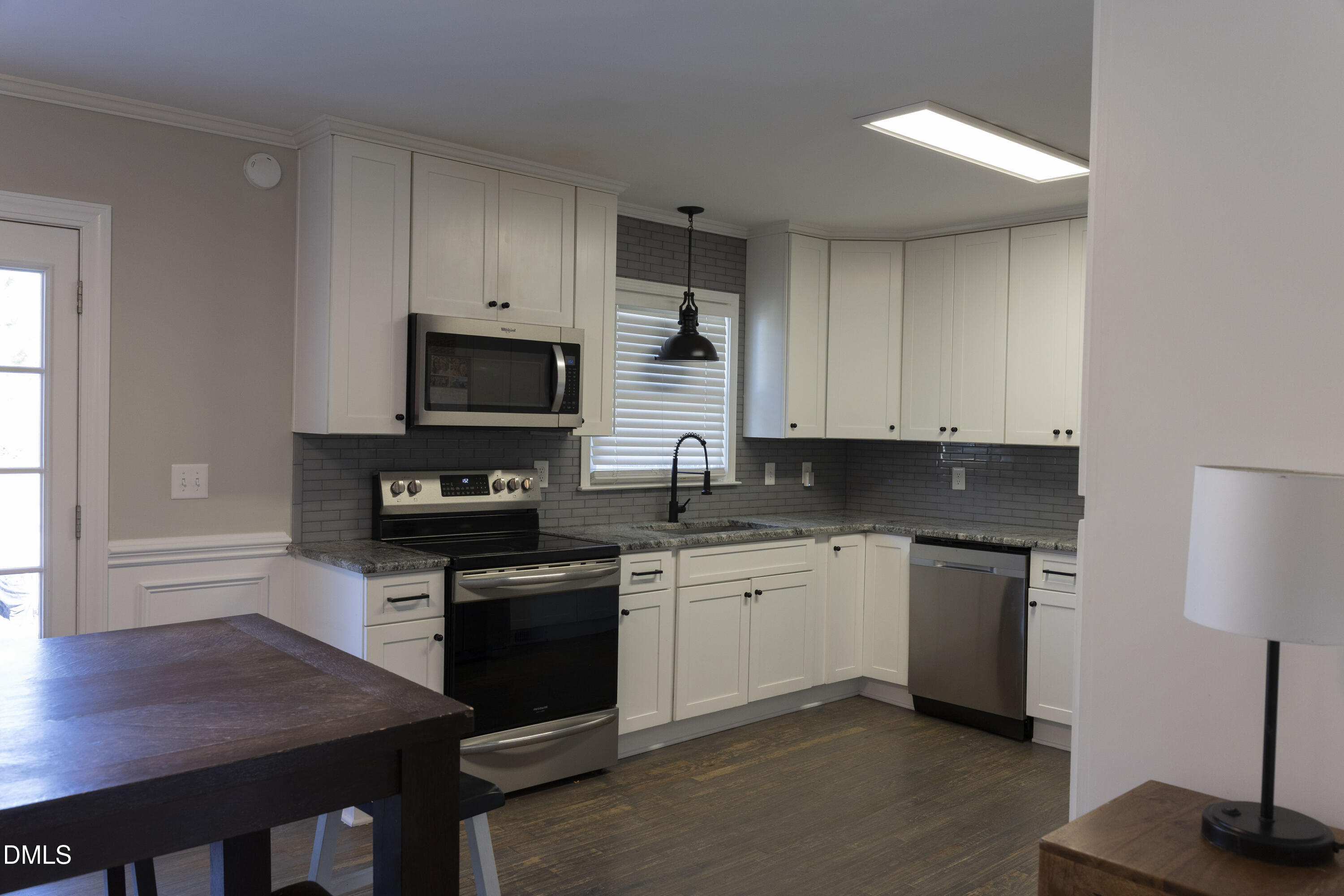 7301 Cleveland School Road Garner, NC 27529 - Photo 11 of 73 a kitchen with granite countertop a stove and a sink