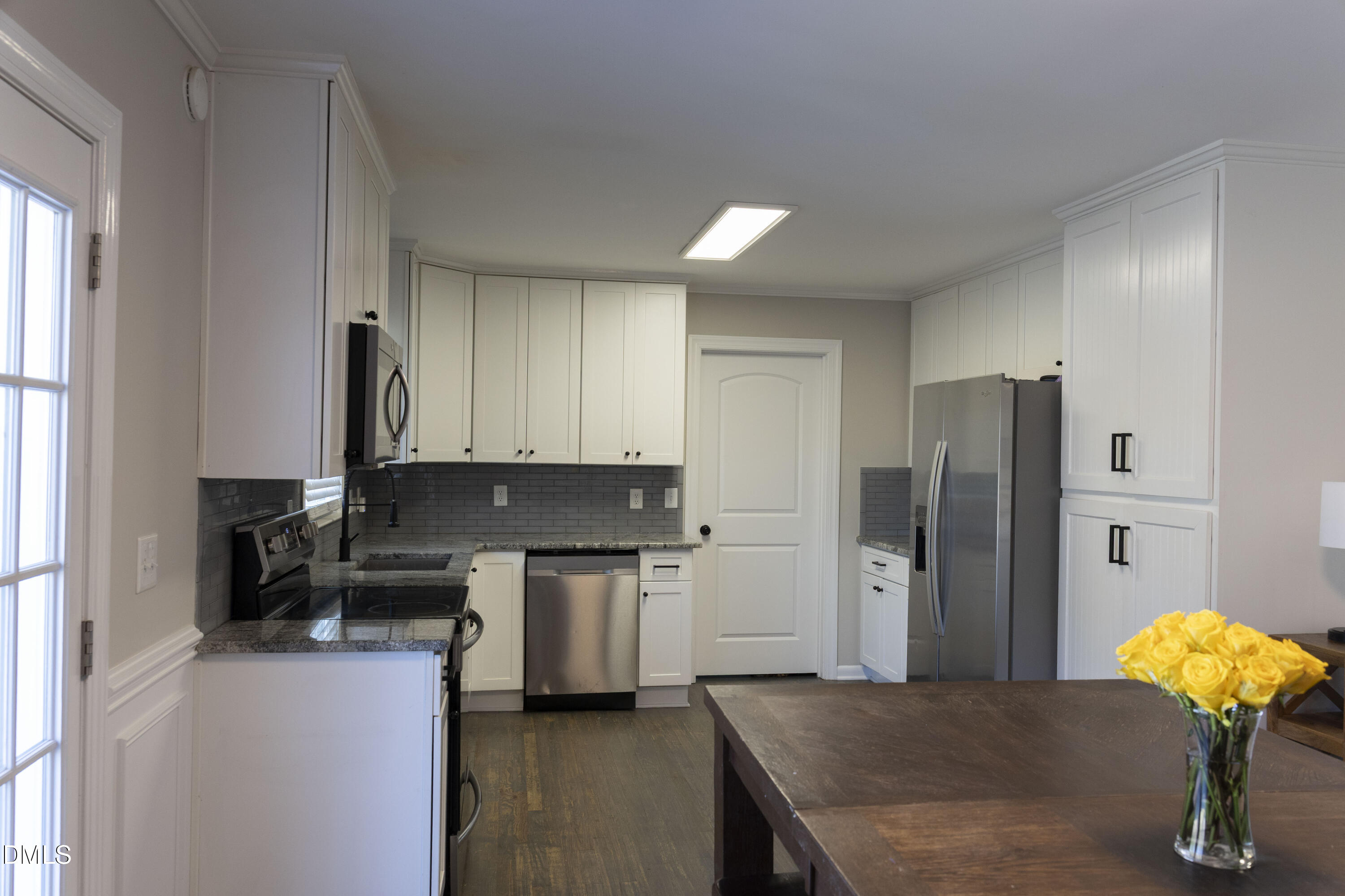 7301 Cleveland School Road Garner, NC 27529 - Photo 12 of 73 a kitchen with stainless steel appliances granite countertop a refrigerator a stove a sink dishwasher and a refrigerator with wooden floor