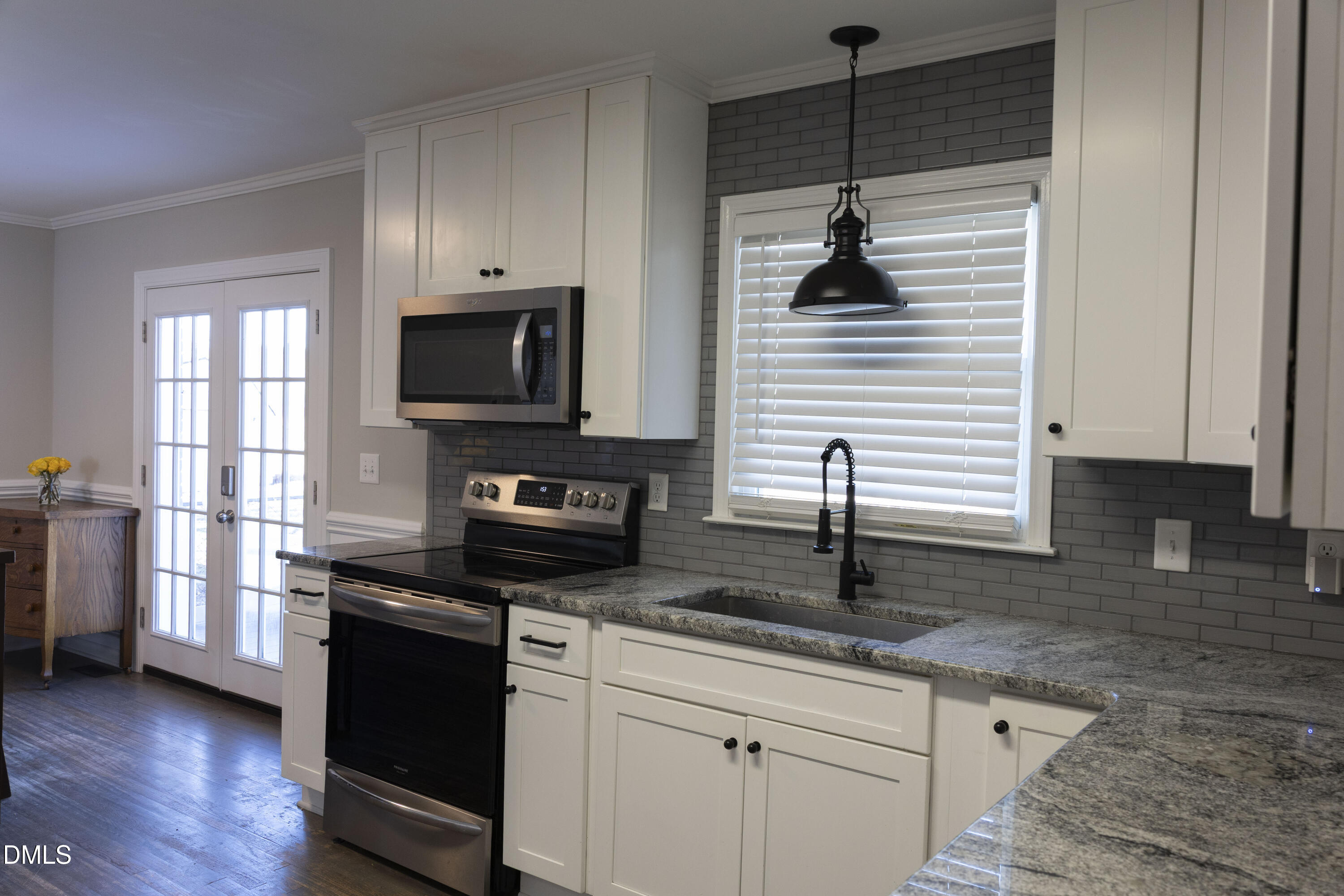 7301 Cleveland School Road Garner, NC 27529 - Photo 14 of 73 a kitchen with stainless steel appliances granite countertop a stove a sink and a microwave