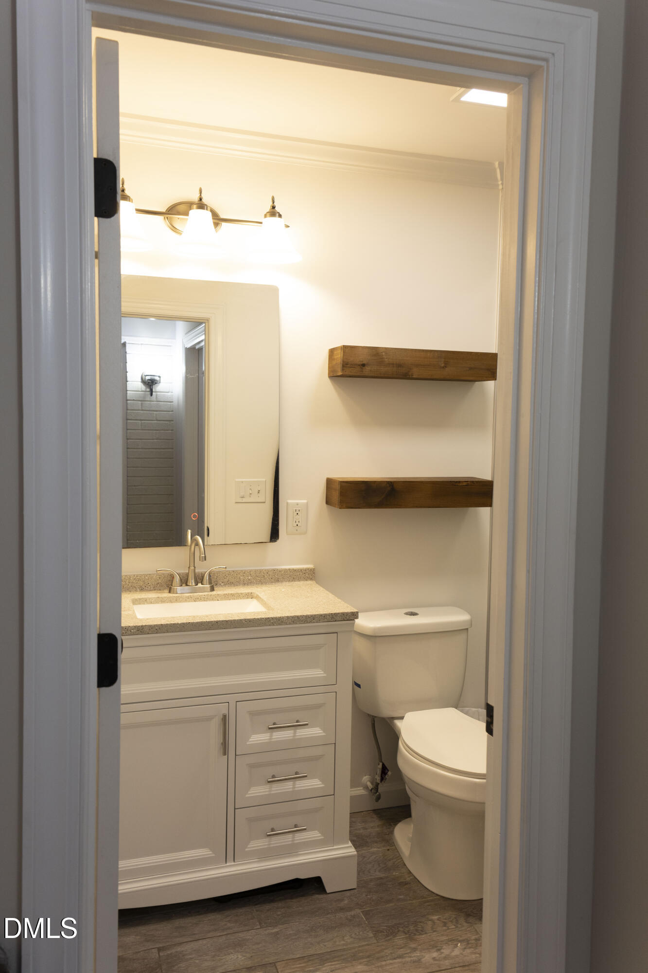 7301 Cleveland School Road Garner, NC 27529 - Photo 21 of 73 a bathroom with a toilet a sink and a window