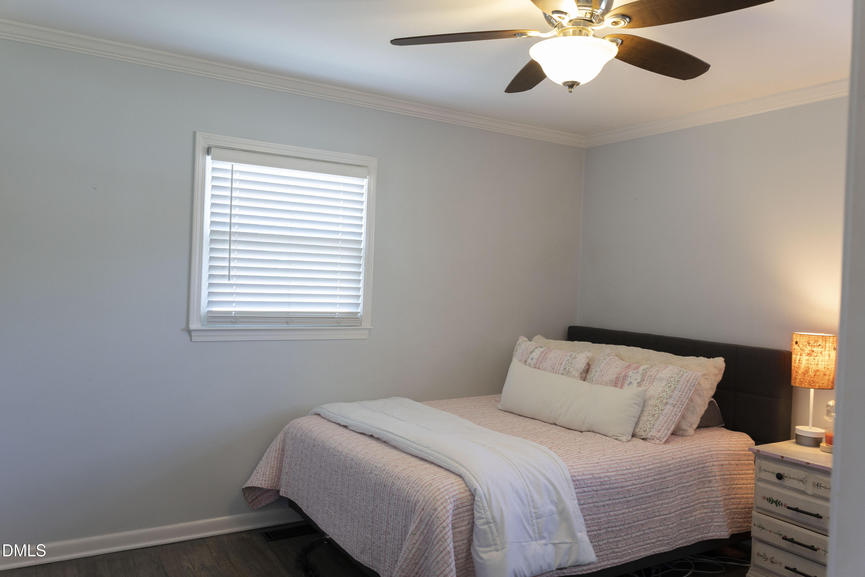 7301 Cleveland School Road Garner, NC 27529 - Photo 35 of 73 a bedroom with a bed and a chandelier