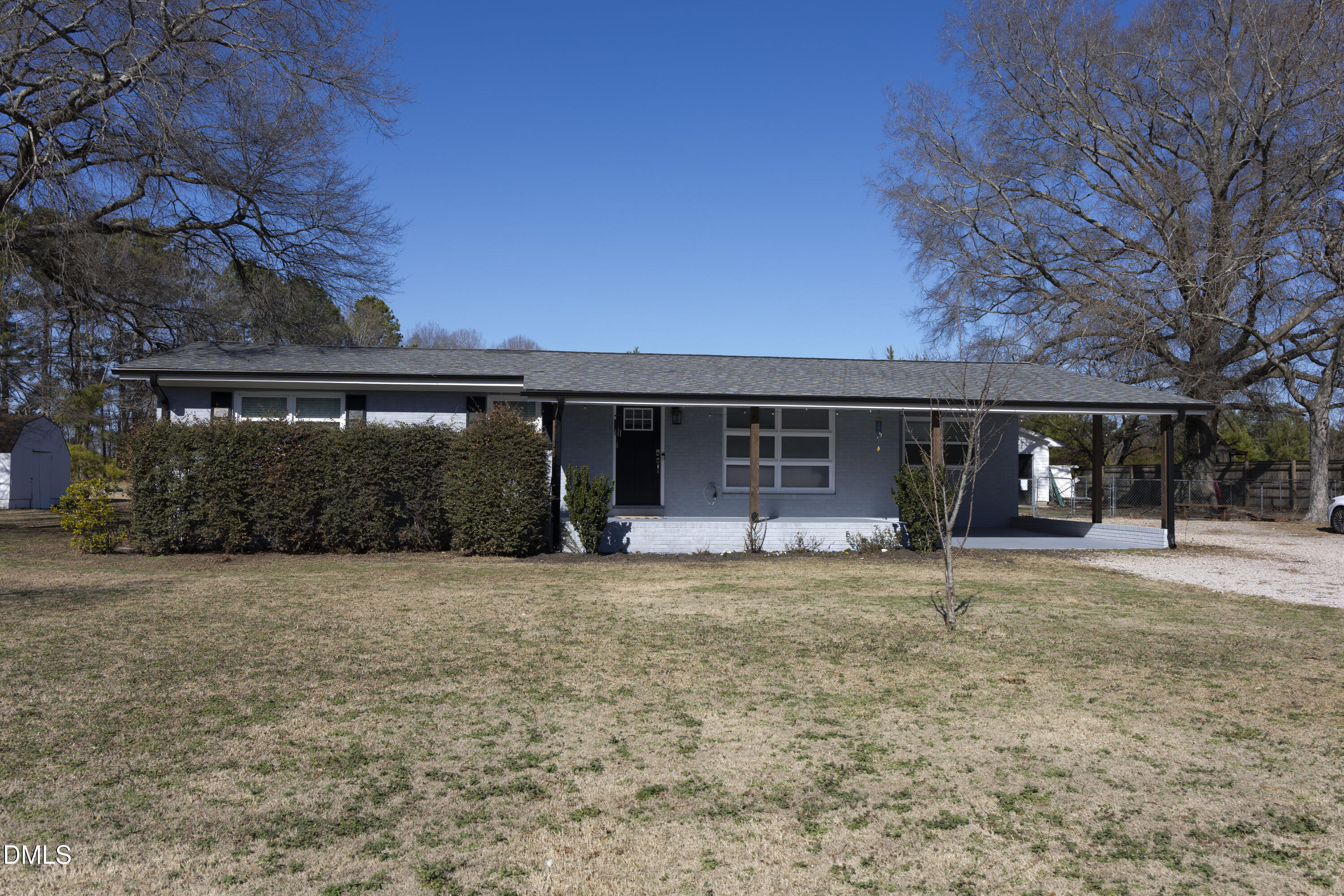 7301 Cleveland School Road Garner, NC 27529 - Photo 54 of 73 a front view of a house with a garden and trees