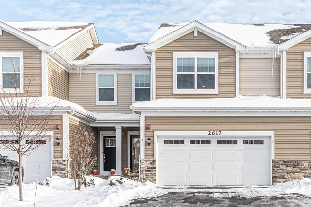 a view of a house with a yard and large windows